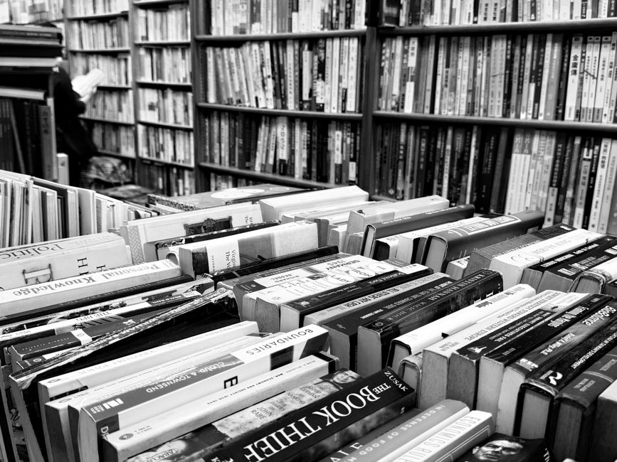 A vibrant collection of books neatly arranged on a bookshelf indoors.