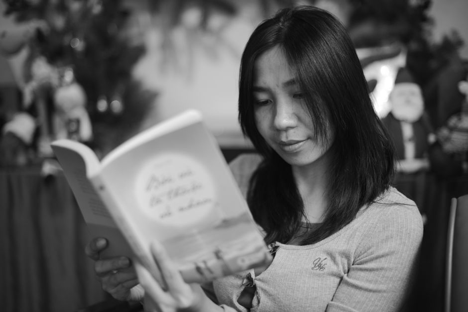 Woman relaxing with a book and a warm drink. Cozy indoor setting for tranquility and leisure.