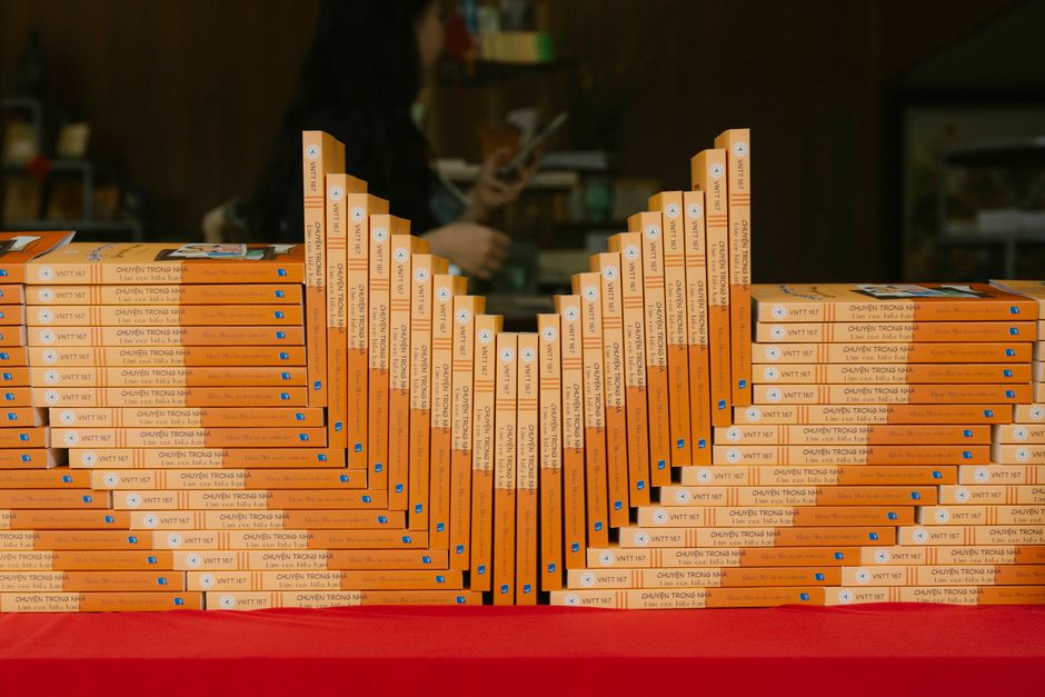 A variety of books neatly arranged on a wooden bookshelf.